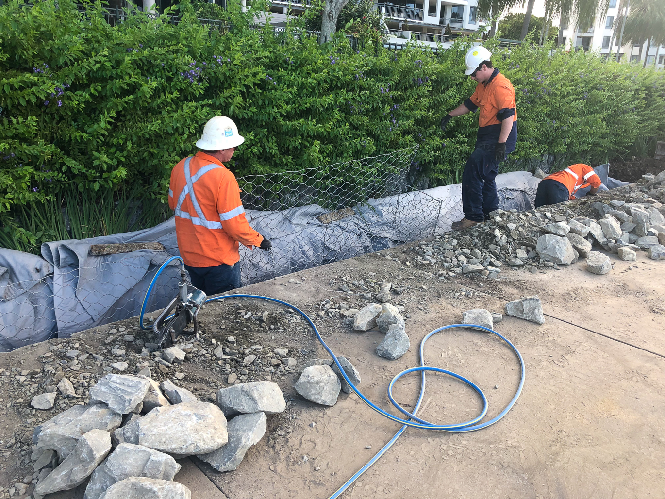 People working on the Mariners Reach Riverwalk Remediation