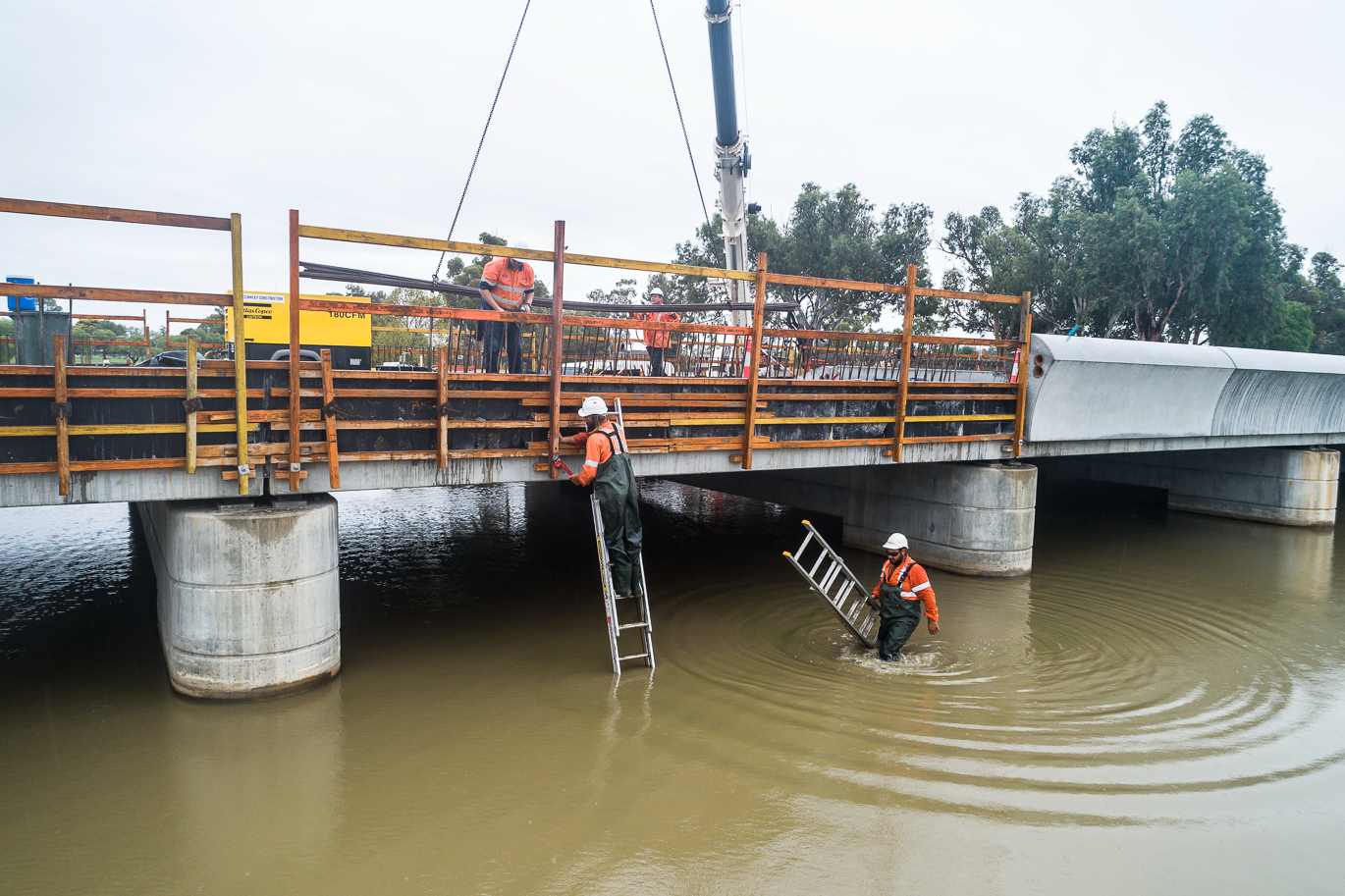 Working in and above water at the Camp Street Bridge