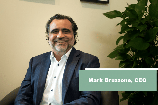 Mark Bruzzone sitting in his office