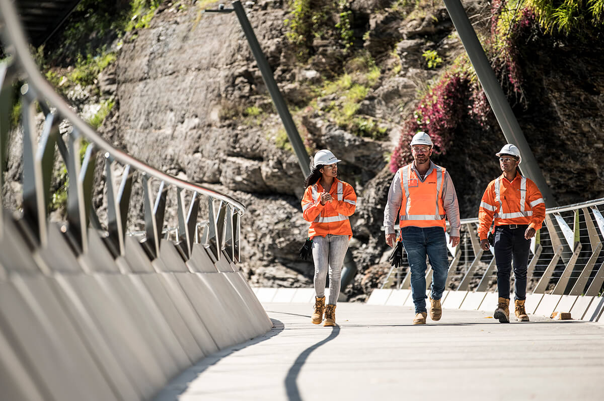Construction workers walking along completed Parramatta Bridge